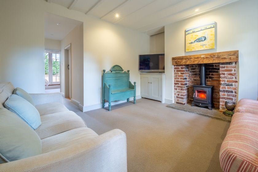 Cozy Living Room with Wood Burning Stove and Brick Fireplace
