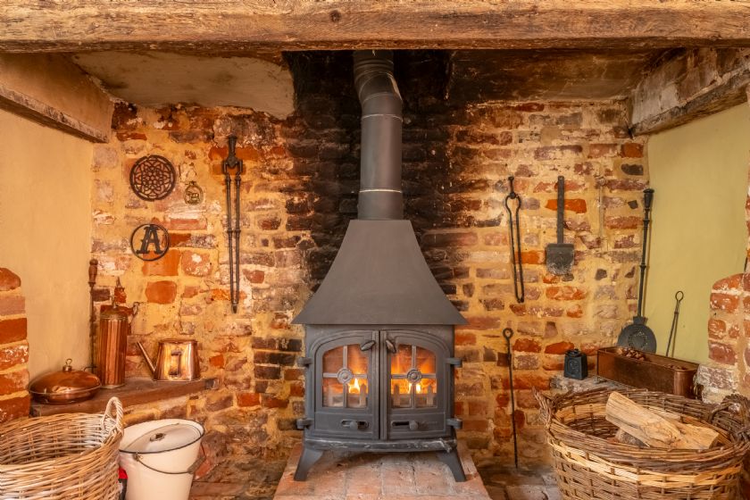 Traditional Wood Burning Stove with Exposed Brick Chimney