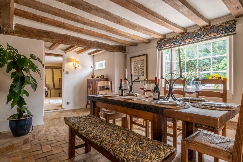 Rustic Dining Room with Wooden Table and Terracotta Floor