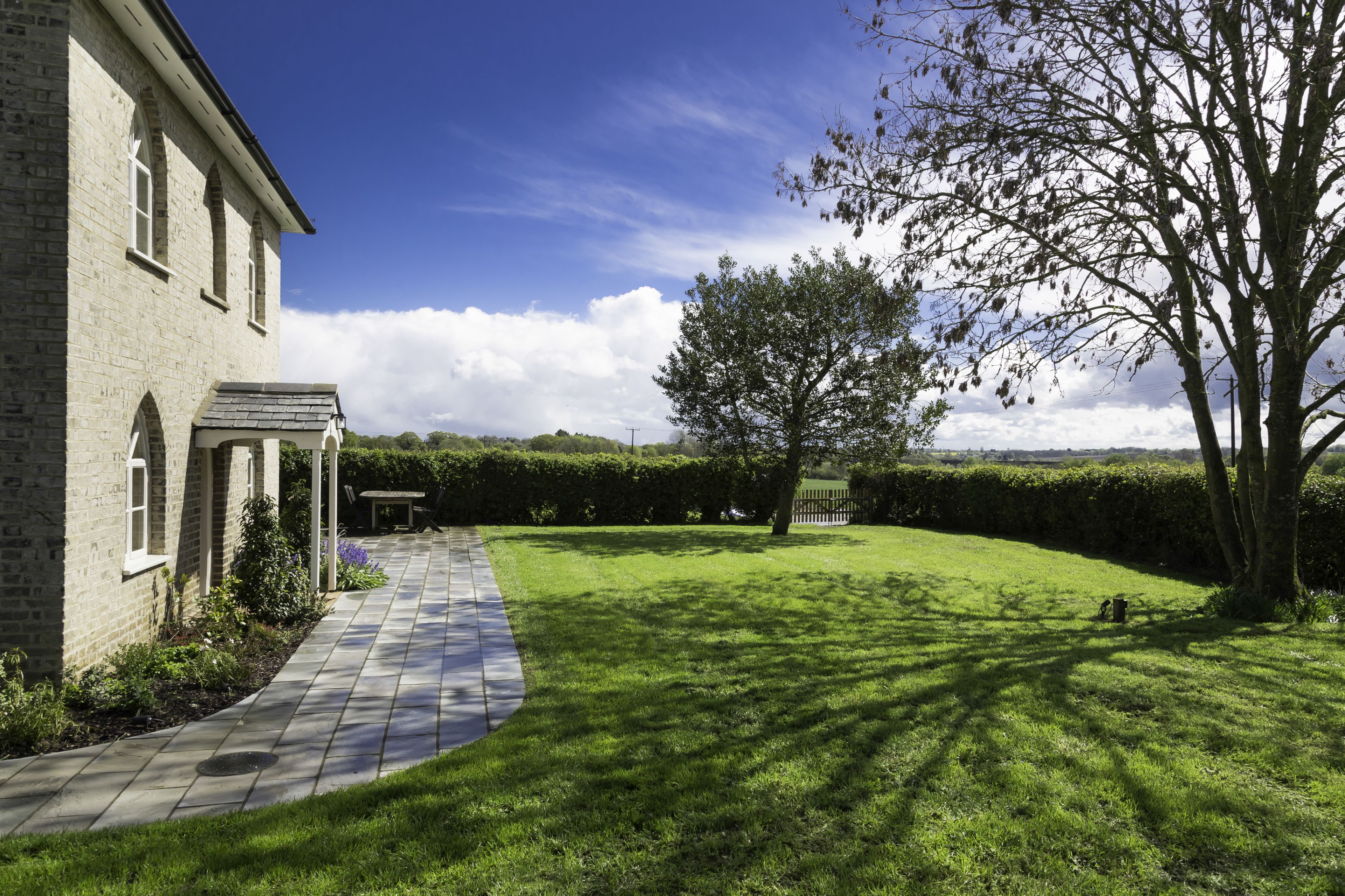 Garden view with stone path and countryside beyond