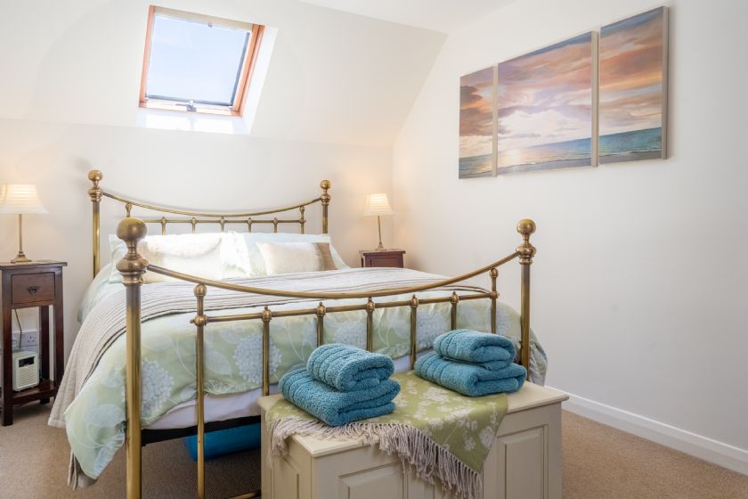 Another view of the bedroom with storage chest