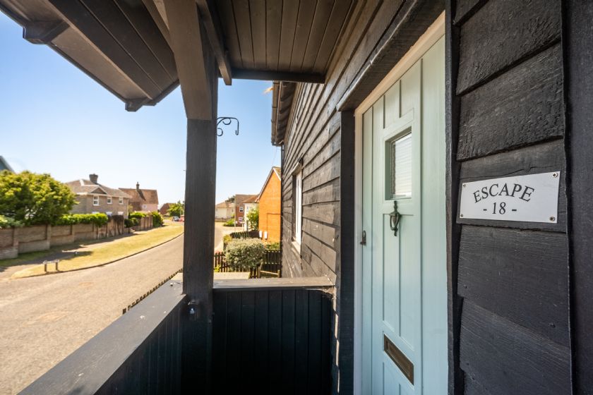 Exterior cottage entrance with 'Escape' sign