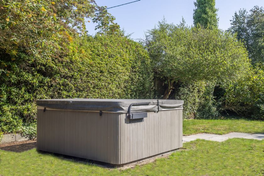 Private hot tub in garden setting surrounded by trees