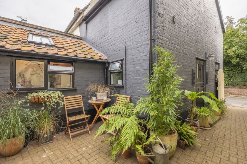 Wider view of the courtyard showing more plants and outdoor seating area