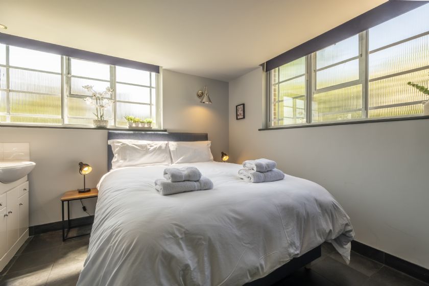 Bright bedroom with white linens and natural light
