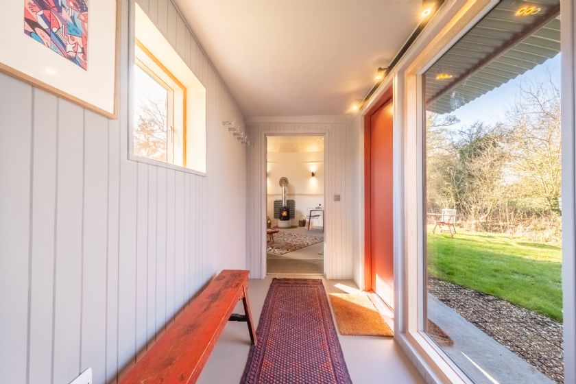 Entrance hallway with bench and large windows