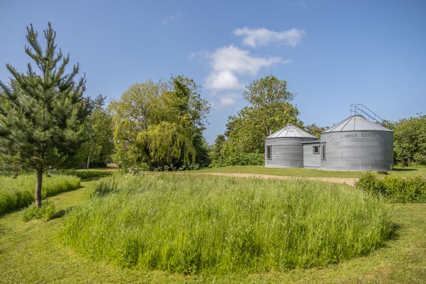 Ground-level view of the silo buildings and landscape