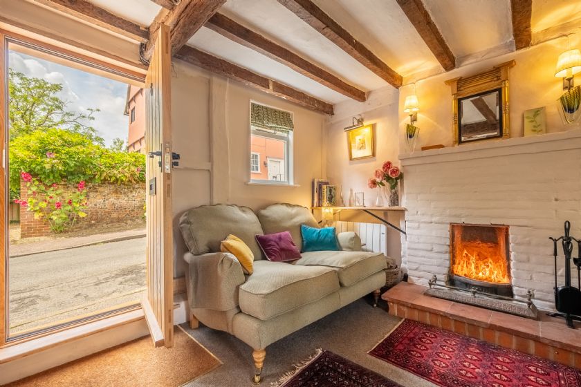 Cosy living room with beamed ceiling and fireplace