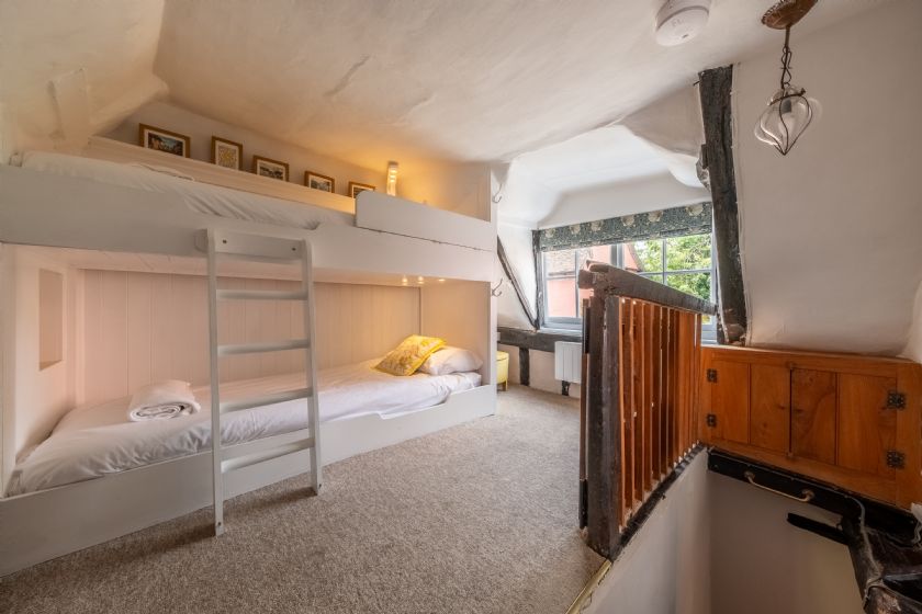 Bedroom with bunk beds and wooden beams