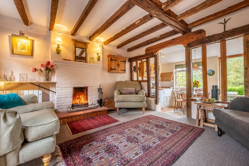 Living room with wooden beams and fireplace