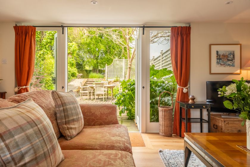 Living room with garden views and orange curtains