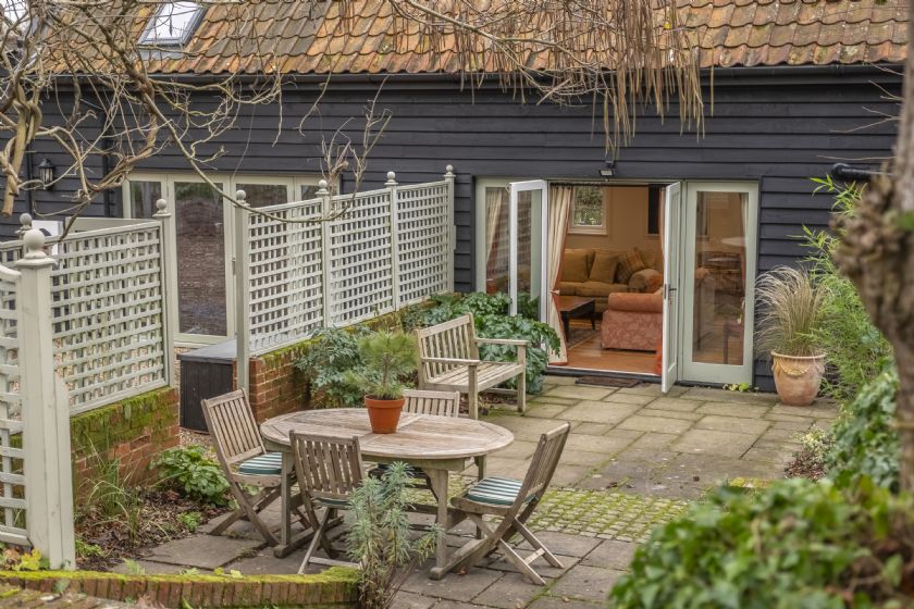 Patio area with garden furniture and barn exterior